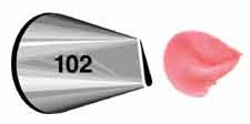 Metal piping tip labeled 102 with a narrow, angled opening, shown next to a pink icing petal shape, demonstrating its use for creating floral designs.