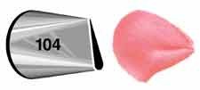 Metal piping tip labeled 104 next to a pink icing shape resembling a petal, demonstrating the tip's narrow, curved opening used for creating floral designs.