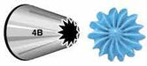 Metal piping tip labeled 4B with a finely jagged open star design, shown next to a blue icing decoration featuring a detailed, ridged starburst shape.