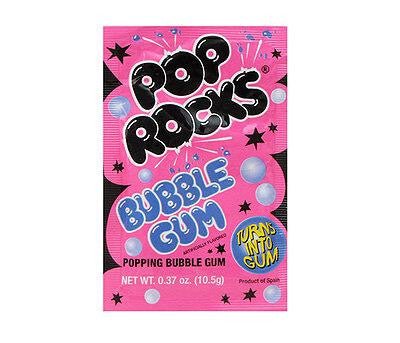 Bright pink packet of Pop Rocks Bubble Gum popping candy – features bold black 'Pop Rocks' logo, blue 'Bubble Gum' text, and fun design elements like stars, bubbles, and bursts in black, white, purple, and blue – labeled 'Turns into Gum' and 'Popping Bubble Gum' at the bottom, 0.37 oz (10.5g) – playful retro-style packaging perfect for candy lovers and party favors.
