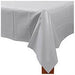 Silver rectangular plastic table cover draped over the corner of a table, with a smooth surface and slight folds along the edges.
