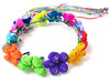 Colorful flower crown headband with bright fabric flowers in orange, green, purple, yellow, red, pink, and blue, accented with multicolored ribbon streamers.