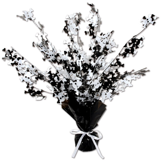 Black and white foil table centerpiece featuring cascading skull-and-crossbones cutouts, wrapped at the base in black foil with a white ribbon tied around it.