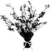Black and white foil table centerpiece featuring cascading skull-and-crossbones cutouts, wrapped at the base in black foil with a white ribbon tied around it.