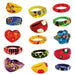 Assorted acrylic rings in a variety of bright colors, shapes, and designs. Includes round, heart, flower, and oval-shaped rings in red, yellow, blue, green, purple, and orange. Designs feature swirls, polka dots, abstract patterns, and floral motifs, with playful combinations of contrasting colors and painted details.