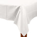 White rectangular plastic tablecloth draped over the edge of a table, with one corner hanging down neatly to show the smooth texture and clean finish.