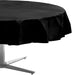 Round table covered with a black tablecloth, draped evenly over the edges, with a metal table base visible underneath.