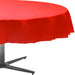 Red round table cover draped over a circular table with a metal base, displayed against a white background.
