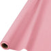 Roll of light pink table cover with a smooth finish, partially unrolled to show fabric texture, placed on a white background.