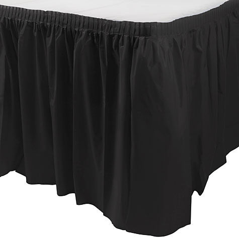 Black pleated plastic table skirt attached around the edge of a rectangular table with a white tabletop.