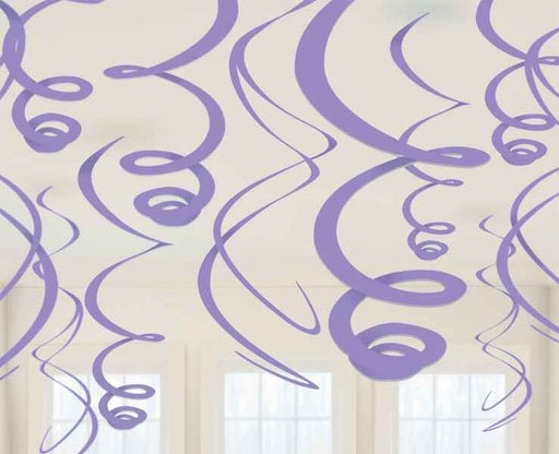 Purple swirl ceiling decorations hanging in varying lengths from a ceiling, set against a softly lit room with white-trimmed windows.