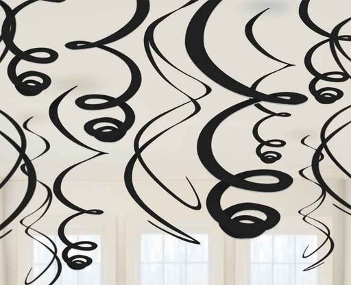 Black hanging swirl decorations suspended from the ceiling in various lengths, creating a festive and dynamic display against a cream background with white framed windows.