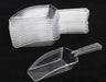 A set of 12 clear plastic scoops with flat handles, stacked together, with one scoop placed separately in front. Ideal for serving candy, snacks, or bulk food items at events or parties.