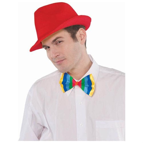 A man wearing a bright red fedora and a large, colorful bow tie with red, blue, green, and yellow stripes over a white shirt.