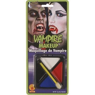 A packaged vampire makeup kit featuring face paints in white, red, blue, and black. The set includes a small brush and sponge applicator. The packaging displays images of people with dramatic vampire makeup, emphasizing bold, theatrical designs ideal for Halloween or costume parties. The text reads "Vampire Makeup" with the French translation "Maquillage de Vampire."