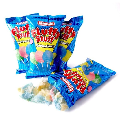Blue cotton candy bags labeled 'Fluffy Stuff' by Charms, with colorful cotton candy illustrations on the packaging and some cotton candy spilled out in front.