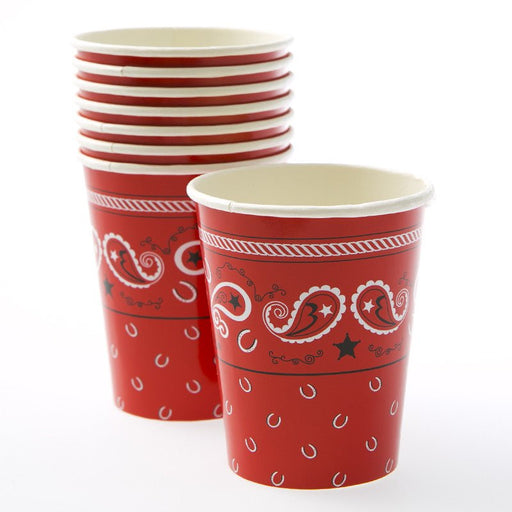 Stack of red 9 oz paper cups with a Western bandana design. The cups feature white and black paisley patterns, stars, and small horseshoe motifs on a bright red background, resembling a classic cowboy bandana style.