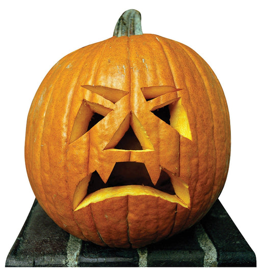 A carved orange pumpkin with an angry expression, featuring slanted triangle eyes, a jagged nose, and a frowning mouth with sharp teeth, sitting on a striped platform.