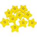 Ten small yellow star-shaped erasers with smiling faces arranged in a scattered pile.