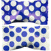 Two pieces of royal blue candy with white polka dot wrappers, shown side by side with a gap in the middle where they have been separated.