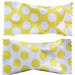 Two pieces of candy with yellow polka dot wrappers, one with a yellow background and white dots, and the other with a white background and yellow dots, placed side by side.