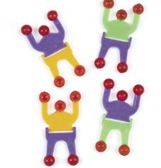 Set of four colorful wall-climbing toy figures with flexible bodies in purple, yellow, and green, each with red sticky suction cups on hands and feet.