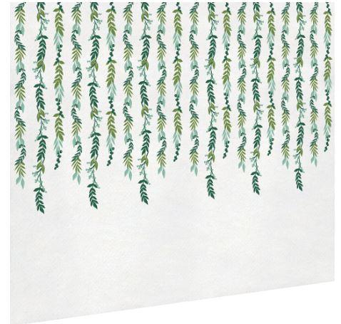 White table cover decorated with cascading green vine patterns along the edges.