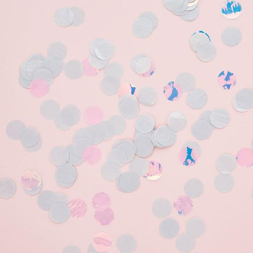 Scattered round confetti pieces in pastel colors of white, pink, and iridescent shades on a light pink background.