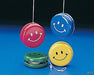 Set of four metal yo-yos in red, blue, green, and yellow, each with a white smiley face printed on the side. Two yo-yos are hanging by their strings, and two rest on a blue surface.