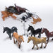 Collection of small plastic toy horses in various colors, including black, white, brown, tan, chestnut, and gray. The horses are molded in different standing and walking poses, with visible detailing on the manes and tails. Several figures are in focus in the foreground, while a larger group is slightly blurred in the background.
