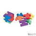Colorful puzzle erasers shaped like interlocking Tetris-style pieces, shown both assembled into a cube and disassembled into separate pieces.
