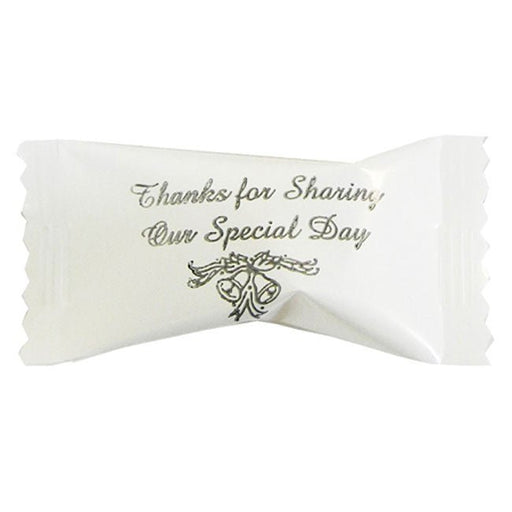 Individually wrapped buttermint cream candy in white packaging with silver script reading 'Thanks for Sharing Our Special Day' above a decorative graphic of wedding bells and ribbon.