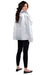 A woman wearing black leggings, black ballet flats, and a shiny silver cape that drapes down to her hips. She is standing with her back turned and looking over her shoulder, smiling, with long, wavy brown hair cascading over the cape.