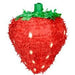 A red strawberry-shaped piñata with a textured, fringed surface. The piñata features a bright green leafy top and small oval accents resembling seeds scattered across its body. Designed for party decoration or candy-filled fun.
