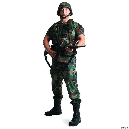Person dressed in a camouflage military-style outfit, including a helmet, short-sleeve shirt, pants, and black combat boots, holding a toy rifle in a ready stance.