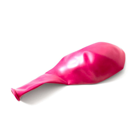 Single uninflated fuchsia balloon lying flat on a white background.