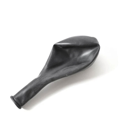 Deflated black latex balloon placed on a white surface, showing its elongated neck and oval body.