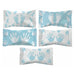 Four pieces of candy with baby-themed wrappers in blue and white. Two wrappers feature small footprints, and two feature handprints, with the designs alternating between blue backgrounds with white prints and white backgrounds with blue prints.