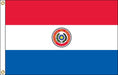 A horizontal tricolor flag with red on top, white in the middle, and blue on the bottom. The center features a circular emblem with a yellow star surrounded by a wreath and the words 'República del Paraguay.'