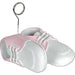 Baby shoe balloon weight featuring a pair of white shoes with pink accents and detailed stitching. A metal loop holder extends upward from one of the shoes, designed to securely hold balloons in place for baby showers or celebrations.