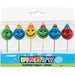 Pack of 6 birthday candles shaped like colorful smiley faces wearing party hats, in green, blue, yellow, and red, each mounted on a wooden stick and arranged in a clear display box with 'PARTY' branding.