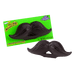 Novelty grape-flavored chewable mustache-shaped candy with a playful design, shown both packaged on a bright green card labeled 'Mustache Chews' and unwrapped for display.