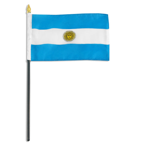 Rectangular flag with three horizontal stripes: light blue on the top and bottom and white in the center. A yellow sun emblem with a face is positioned in the middle of the white stripe. The flag is mounted on a black pole with a white sleeve and a gold spear-shaped tip.