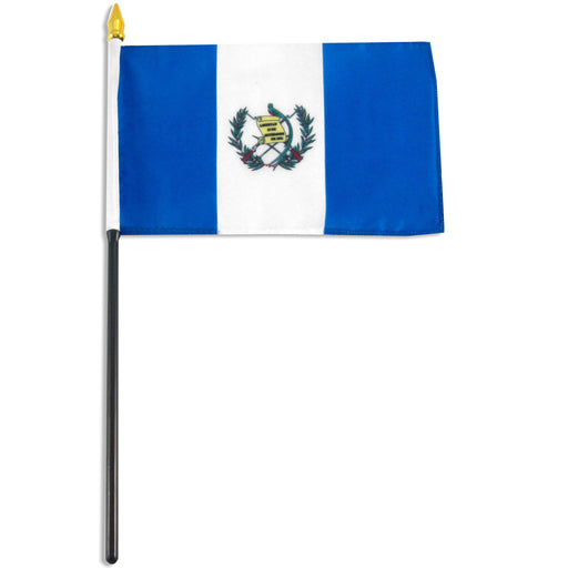 Rectangular flag with three vertical stripes: blue on the left and right, and white in the center. The central white stripe contains a small emblem with crossed weapons, a scroll, and green laurel branches. The flag is attached to a black pole with a white sleeve and a gold spear-shaped tip.